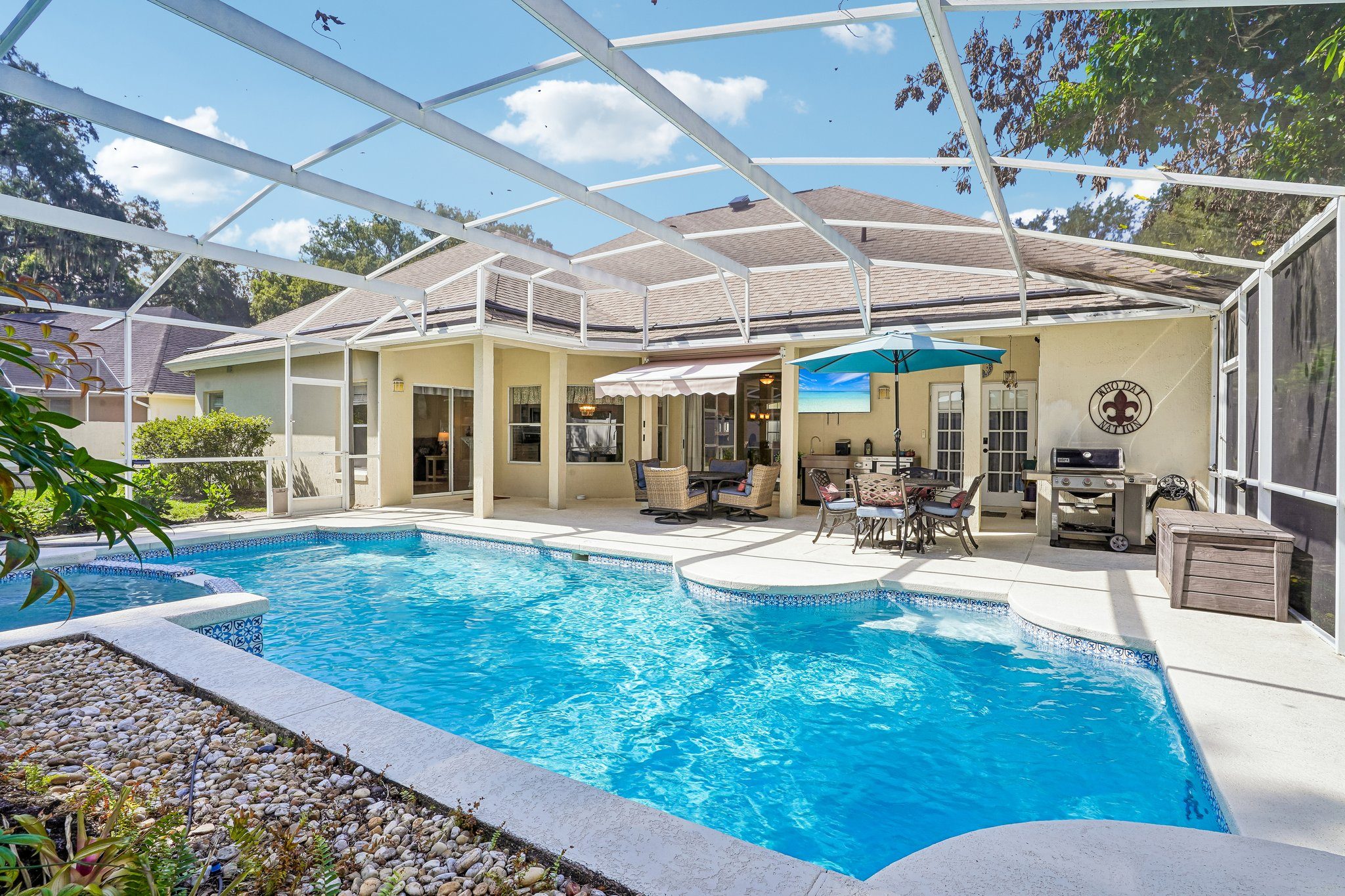 Bright blue swimming pool inside the screened enclosure