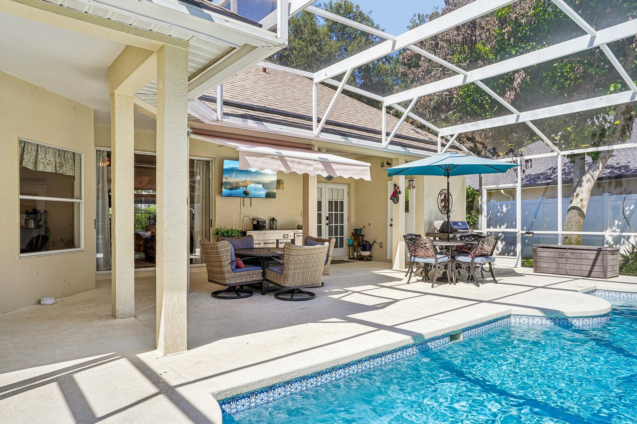 Covered lanai looking across swimming pool